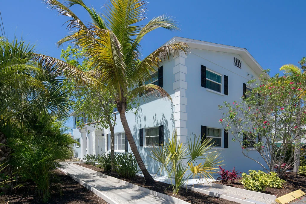 The blue Grevilla fourplex in St. Petersburg under a bright Florida sky